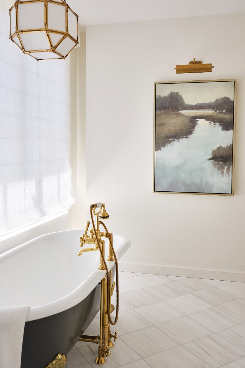 A long dressing room connects to the bath, where a luxurious cast-iron tub invites relaxation.