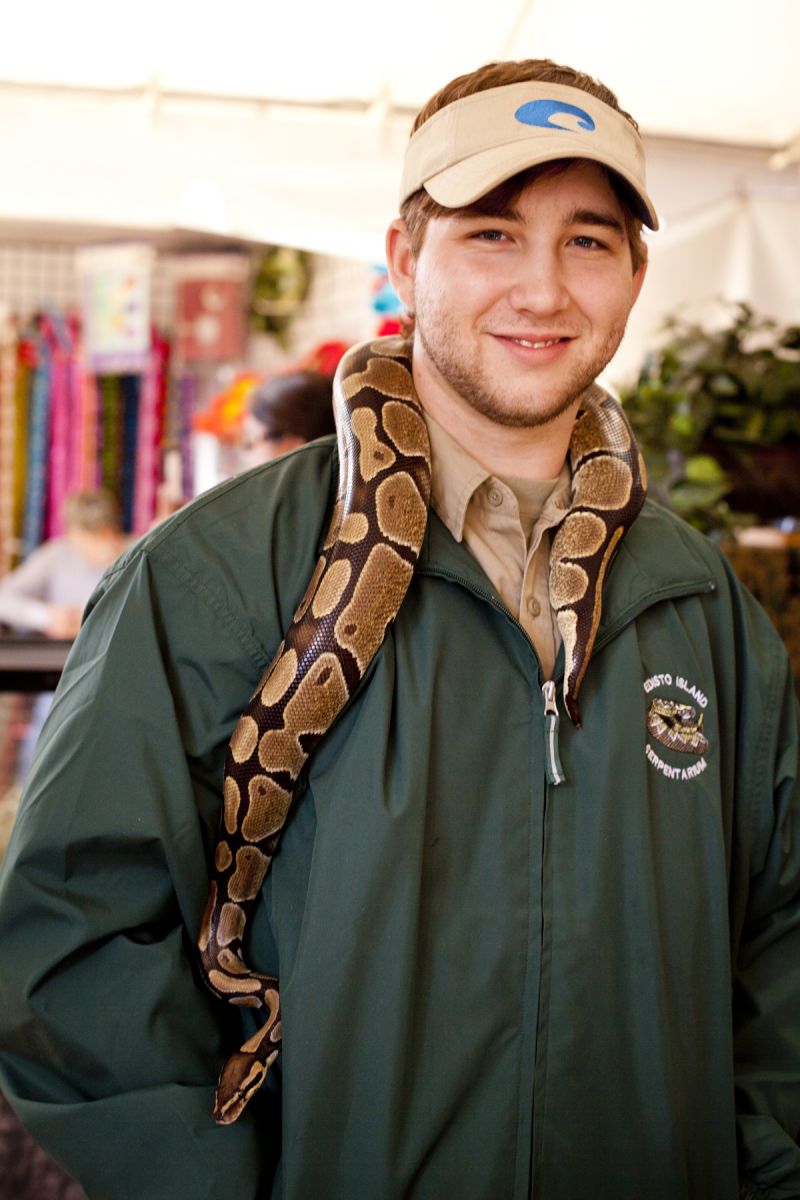 Michael Haug from the Edisto Island Serpantarium with a Ball Python draped around his neck.
