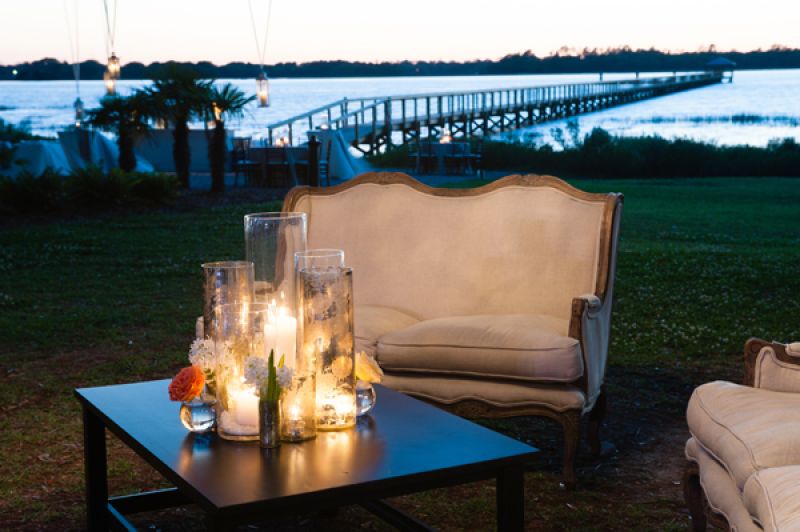 GET THAT GLOW: Bunched glass vessels of varying heights held votive candles and casted soft light over the lounge areas.