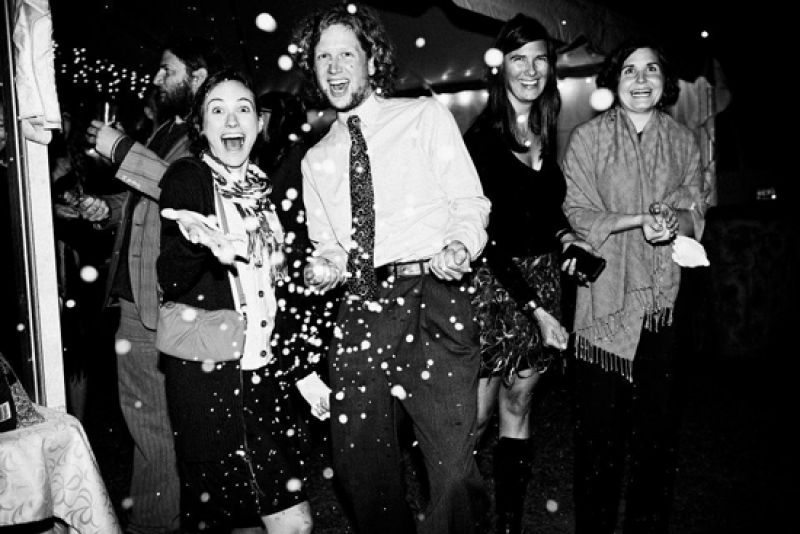 LET IT FLY: Lisa and Seth exited their reception (with their puppy in tow) amid a shower of birdseed.