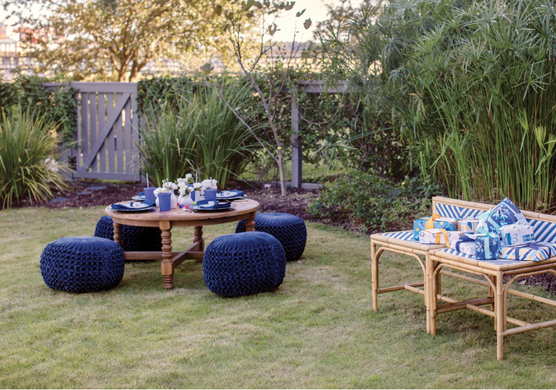 The children’s table is outfitted with pouf ottoman seats, disposable plates and cups, and personal dreidels.