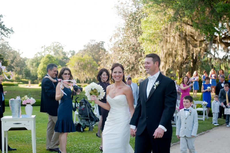 HAND-IN-HAND: The bride and groom retreat up the aisle through the Octagonal Garden.