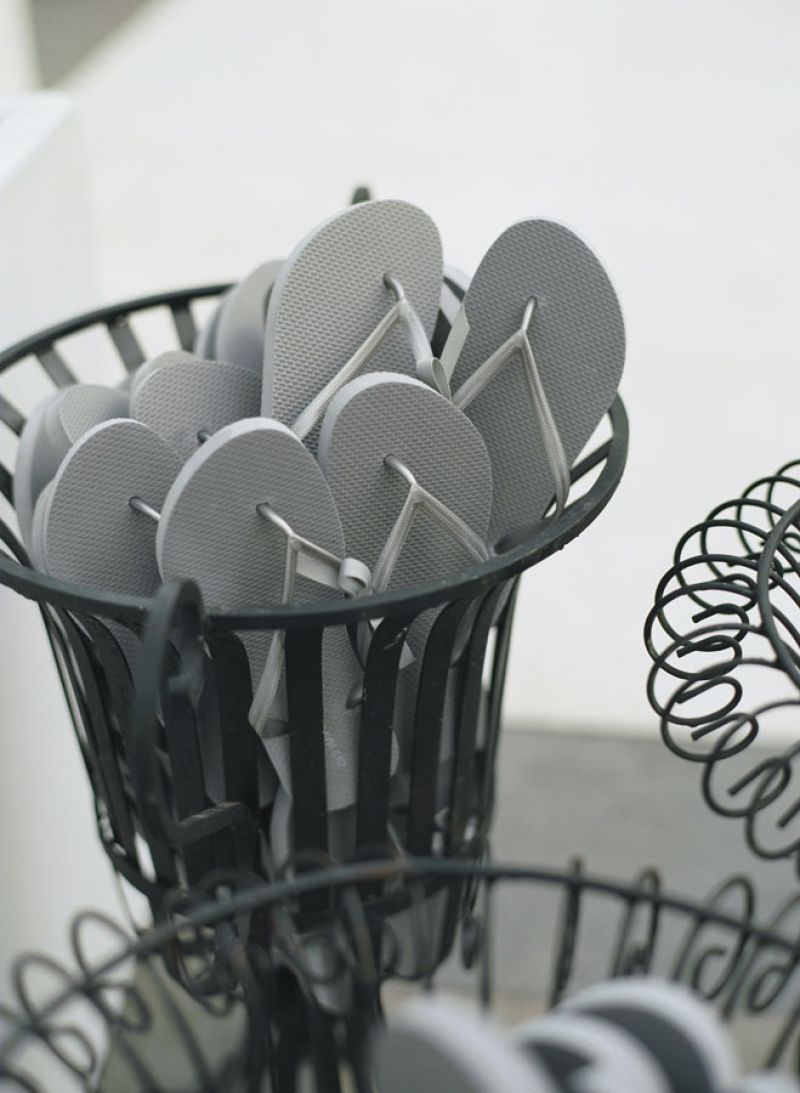 SHOE FAIRY: Wrought iron vessels holding palette pleasing flip-flops were stationed next to the dance floor.