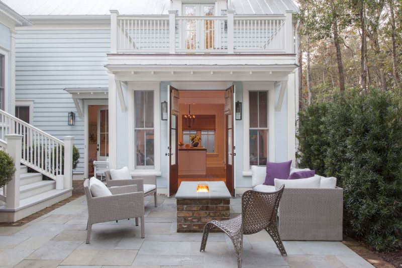 Barn doors open onto the patio, making the outdoor space feel like a natural extension of the interiors.