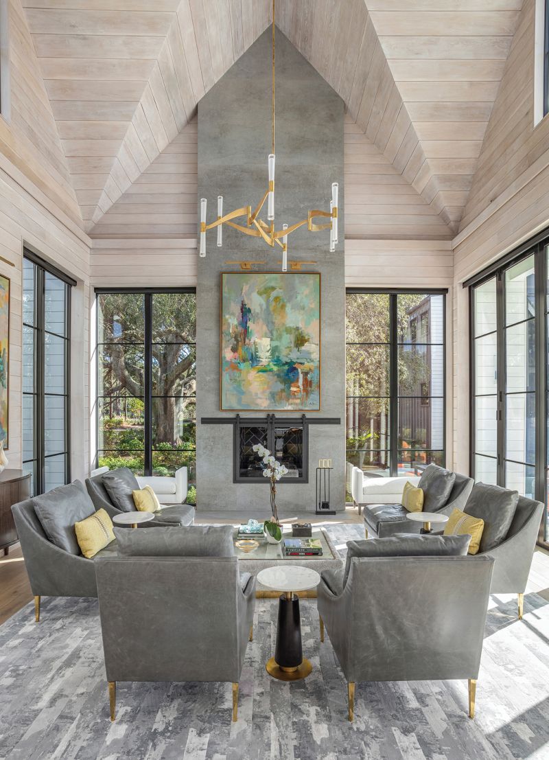 A modern farmhouse on a 12-acre parcel along Bohicket Creek meshes the Lowcountry’s past and present. With a coastal contemporary aesthetic, the home affords plenty of space for art and entertaining, while paying homage to the history of the grand oak-filled property.  Zerkel commissioned artist Amy Dixon to paint the piece above the fireplace. Inspired by the property’s grove of oaks, it accentuates the room’s magnificent vaulted, oak-paneled ceiling.