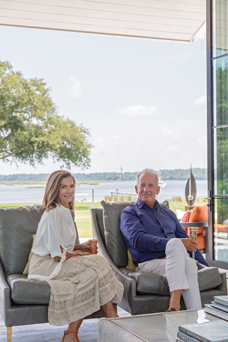 Owner Greg Zerkel (pictured below with his fiancée, Patti Webb) fell in love with the property’s views of Bohicket Creek and tasked architect Chad McDonald with designing a home that capitalized on them, while honoring the heritage of the historical farmhouse that once stood there.