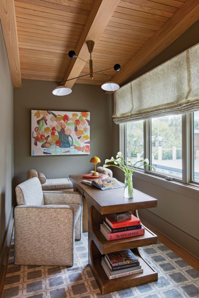 The cozy office space just fits a modern desk and comfy chair upholstered in Henley’s “Hashblocks, Neutral,” which is repeated in the Roman shades.