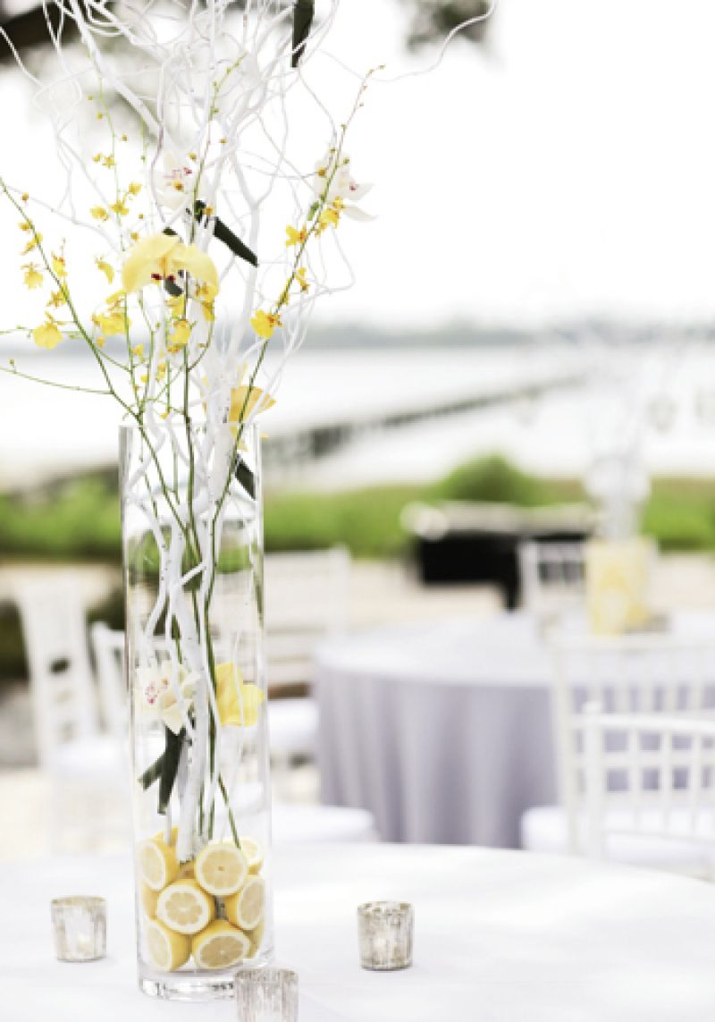 BRANCH OUT: Bare white branches that spoke of spring were paired with strands of orchids and rooted in halved lemons for subtle color.