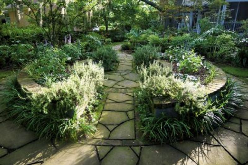 Well-Rounded: This raised garden is the centerpiece to the four garden rooms. The joints between the bluestone pavers were left “tooled” (ungrouted) to allow for moss or plant growth.