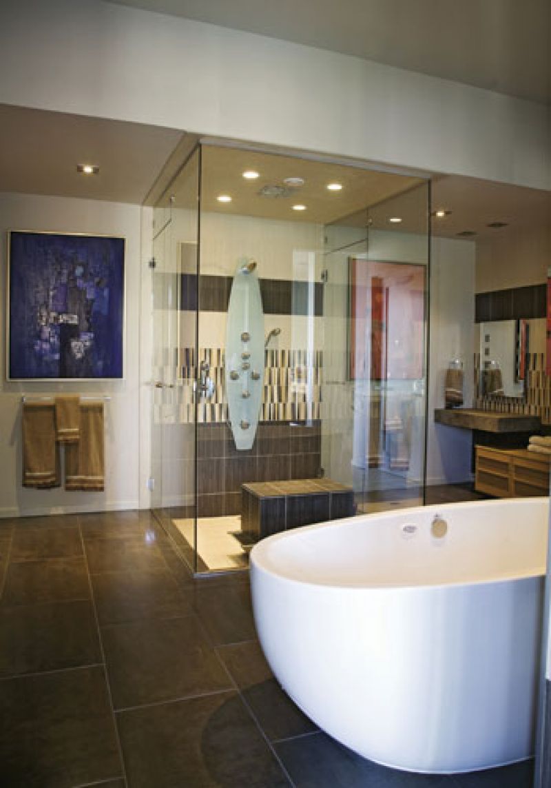 At Ease: The master bath features a soaking tub and a pair of Bertha Schwartz paintings