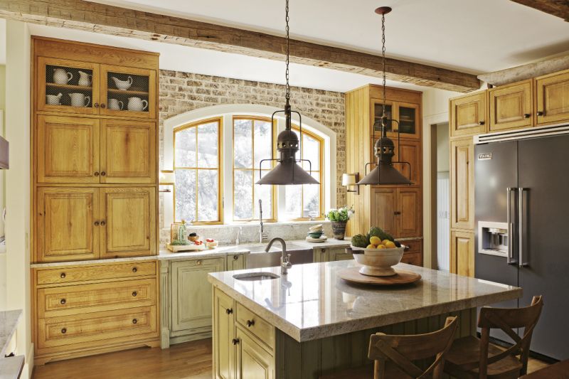 The couple’s furniture-style kitchen is composed of armoires and cabinets customized with varying finishes to create a collected look.