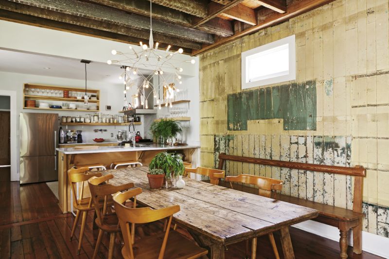 The homeowners opted not to update the east-facing wall with drywall. “We liked that you could see multiple layers of paint from the years of renovations,” Rice says.