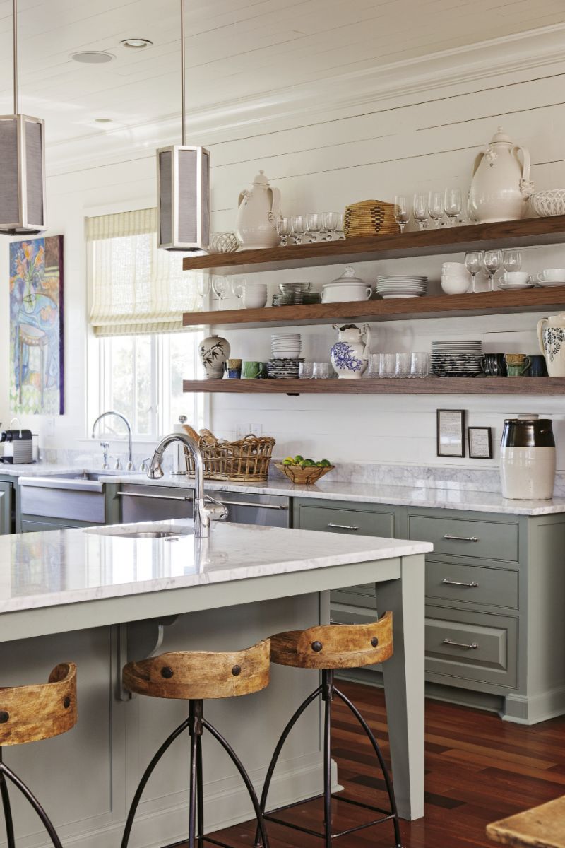 Bishop suggested replacing wall-mounted cabinets with open walnut shelving for storage with more warmth and personality.