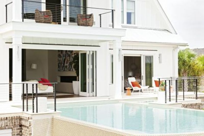 Open-door Policy: Accordian-style doors fold open along the rear of the house, where the living room steps out to the pool.