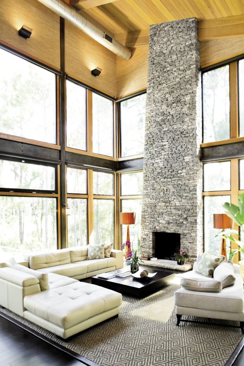 Chris opted to keep the home’s sturdy steel framing exposed in the lofty great  room, which features a 27-foot stacked  stone