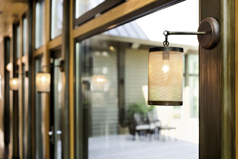 Hand-forged Italian lanterns warm the rear wall of windows.