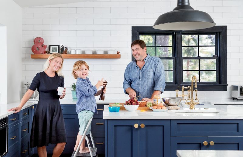 family style: When Mike and Emilee Lata bought the centuries-old abode, the kitchen was outdated, with low ceilings and a lack of natural light. The couple (pictured here with son Henry) worked with David Thompson Architects and Renew Urban to take the cooking space down to the studs and redesign it with a luxe farmhouse vibe.