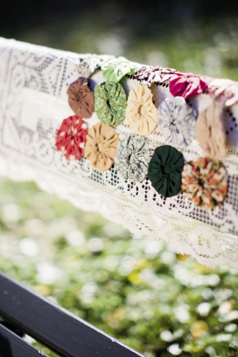 DAPPER DRAPING: Vintage lace and quilt remnants added bursts of color and texture (not to mention comfort) to bench backs.