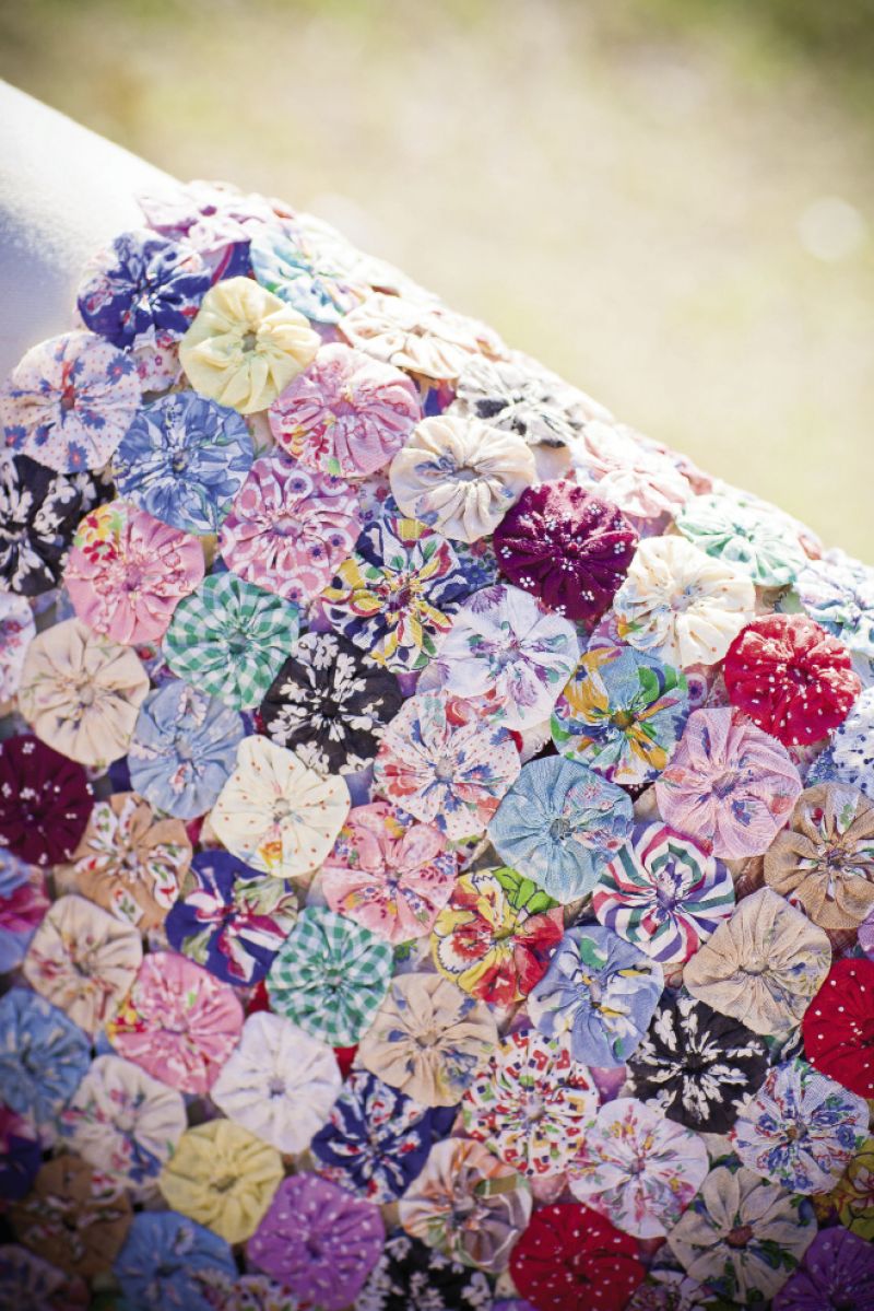 YO-YO, MA: Catherine and her mom scoured flea markets for yo-yo quilts to add color and pattern throughout the reception.
