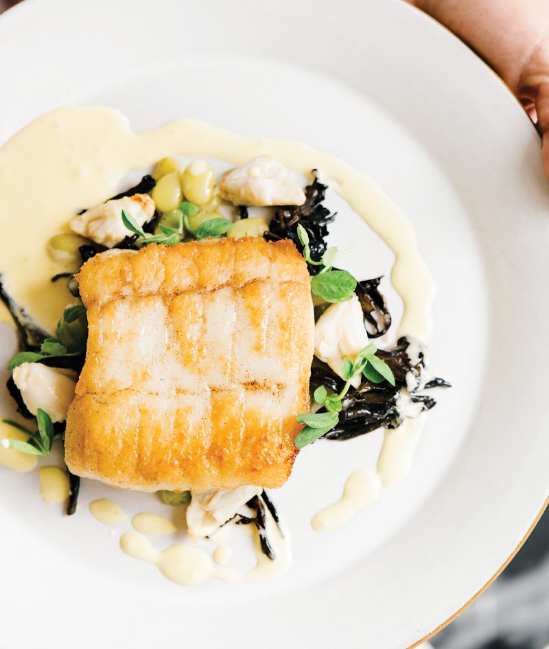 Seared to Perfection:  Flounder Pontchartrain served with chanterelles, blue crab, local legumes, and a sabayon sauce