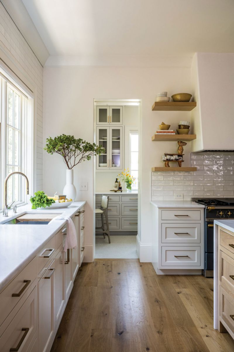 Bright Side: The kitchen features a large marble island, but Debby’s favorite feature is the butler’s pantry. Tucked behind the Lacanche range, the laundry/larder is flooded with light. A c
