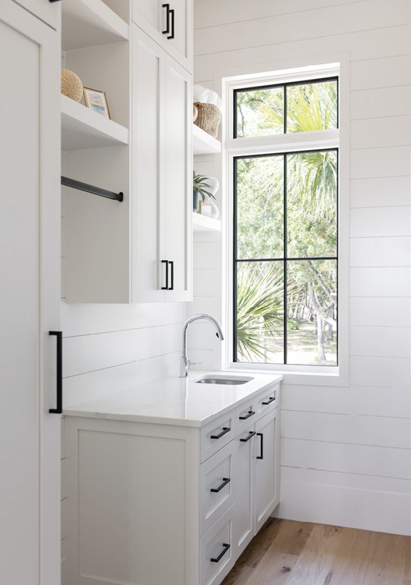 Ship to Shore: Modern, simplified shaker cabinets pair with shiplap on the island and walls to create a clean, simple look in the kitchen, pantry, and laundry room.