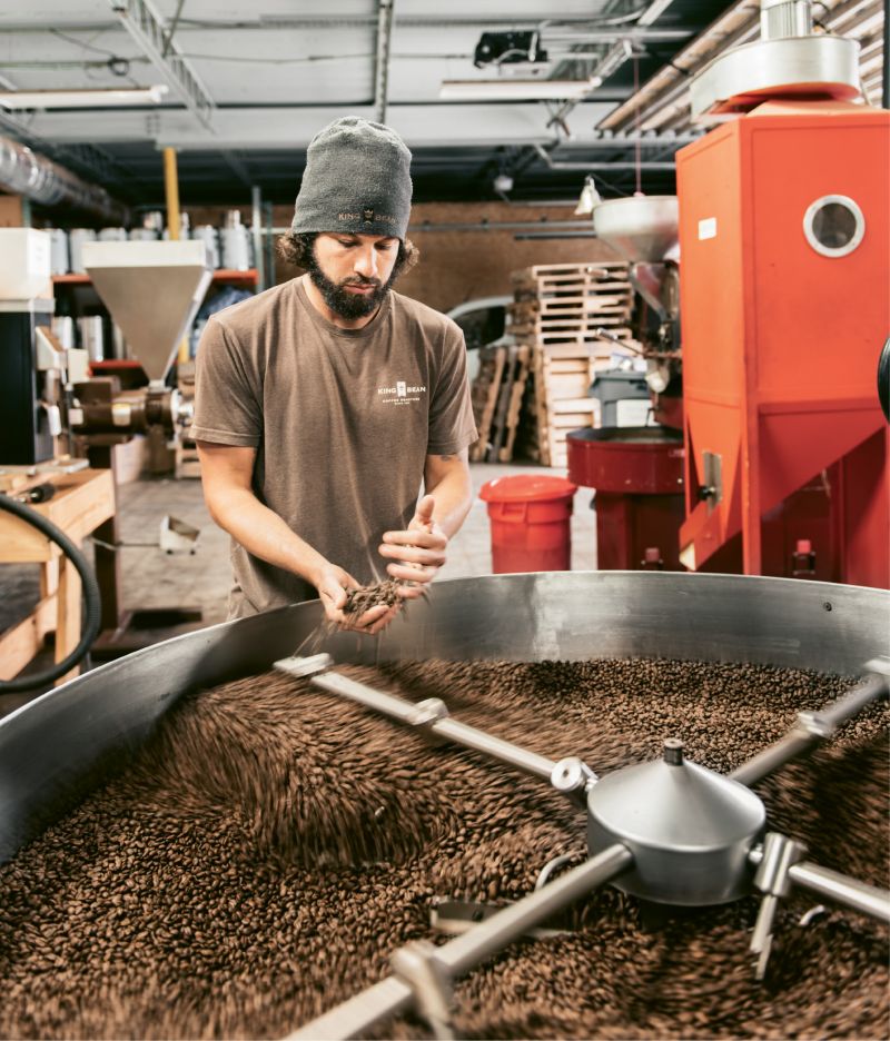 The Daily Grind: At King Bean’s North Charleston facility, head roaster Richie Young and assistant Andrew Hayden roast green coffee beans on a 60-kilo Petrocini, monitoring color, temperature, fragrance, and cracking sounds