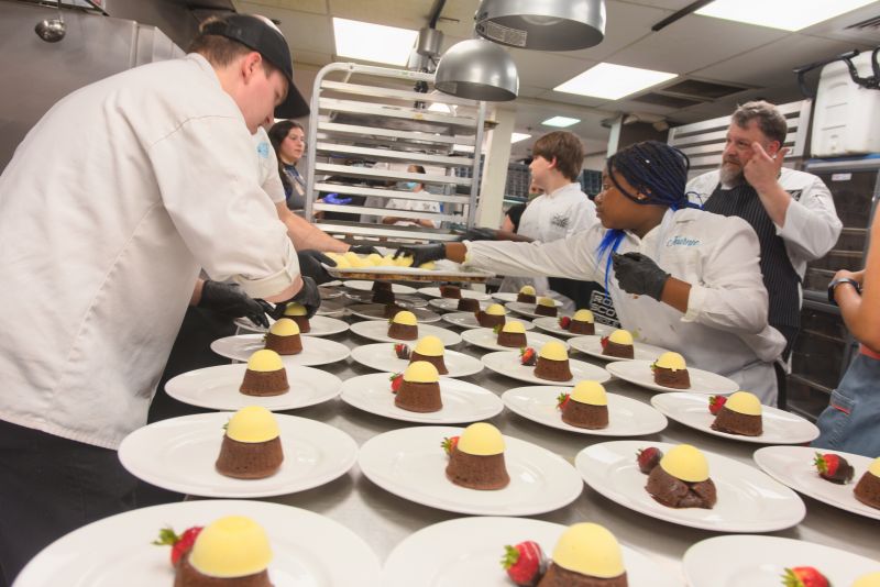 Chocolate lava cakes by Halls Signature Events chef Richard Plaistowe and little chef Trevin Lamber are plated for guests.