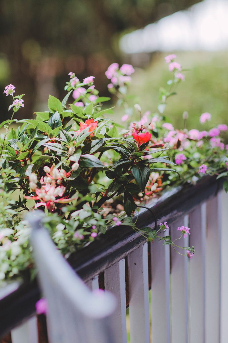 HANGING GARDEN: Colorful floral arrangements hung from porch railings at the Governor Thomas Bennett House.
