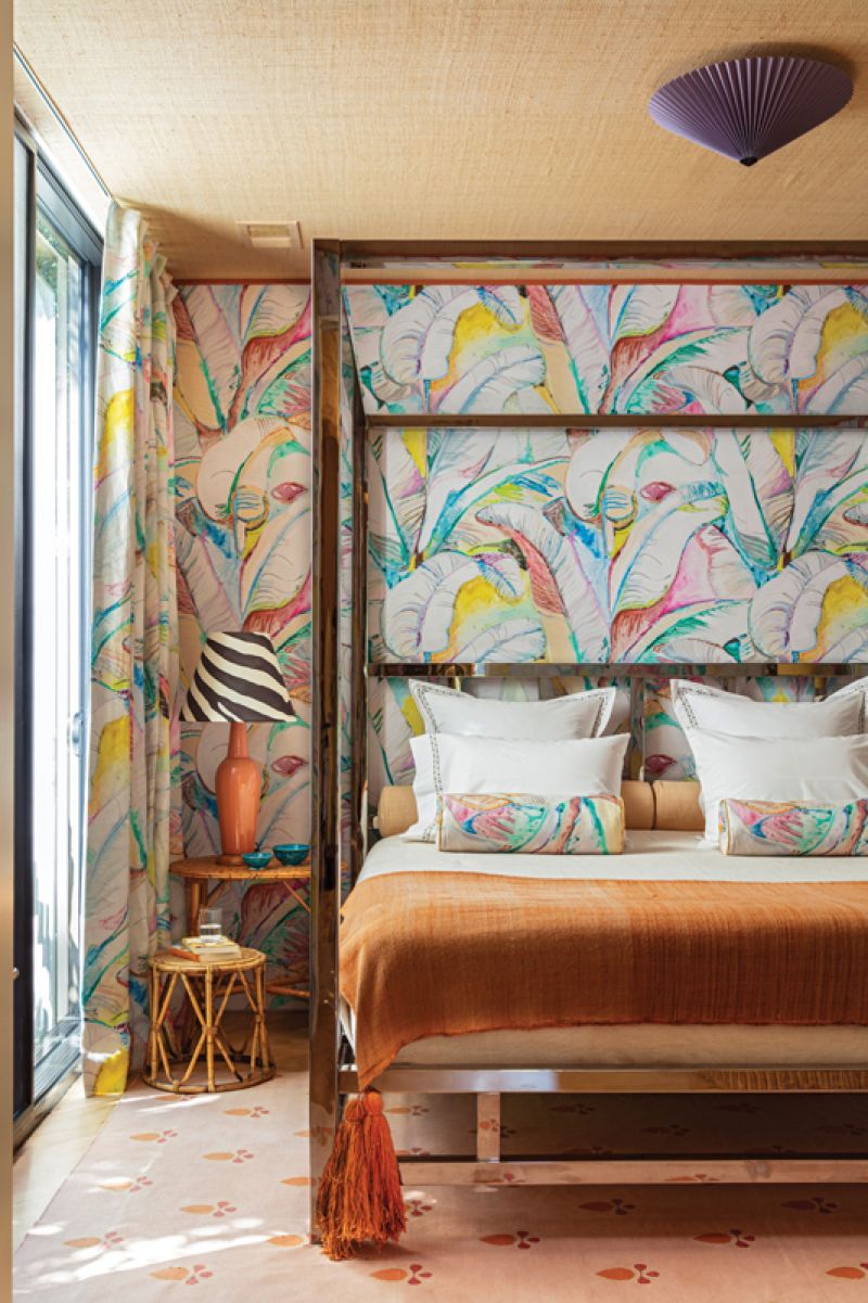 The primary bedroom is swathed in a vibrant, banana-leaf print. A collaboration between Voutsa and CW Stockwell, the pattern is a reinterpretation of Stockwell’s iconic “Martinique” print originally designed for the Beverly Hills Hotel. “For me, it’s a collision of Miami and Los Angeles, two cities I love,” says Hranowsky. She commissioned artist Doug Meyer to create the cameo of Frida Kahlo.