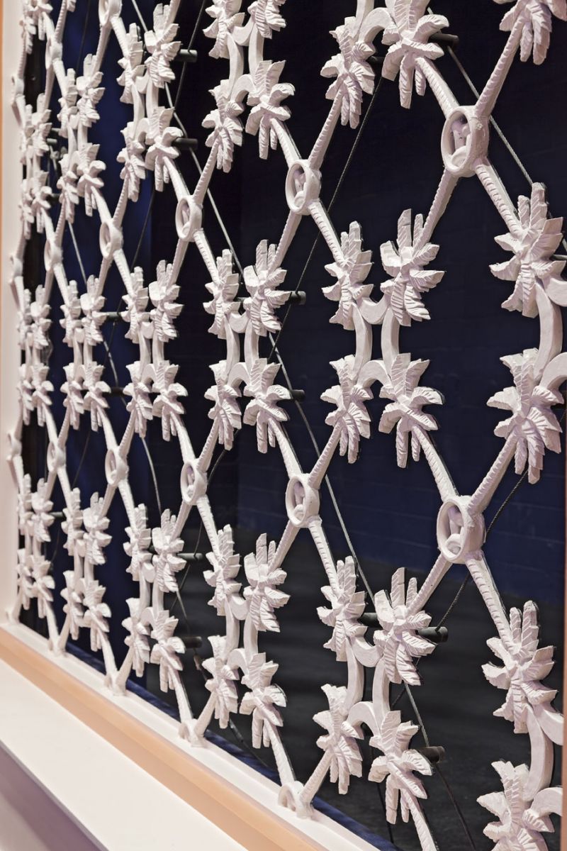 Local iconography was incorporated throughout, including a custom palmetto ironwork lattice fronting a deep indigo background masking the top-tier adjustable acoustical chambers.