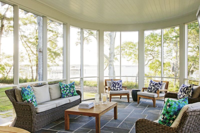 he open-concept floor plan means the living room, dining room, and kitchen are all connected. Sliding glass doors in both the living and dining areas lead out to the back porch, which is partially screened in, ensuring the family can enjoy the outdoors in any weather.