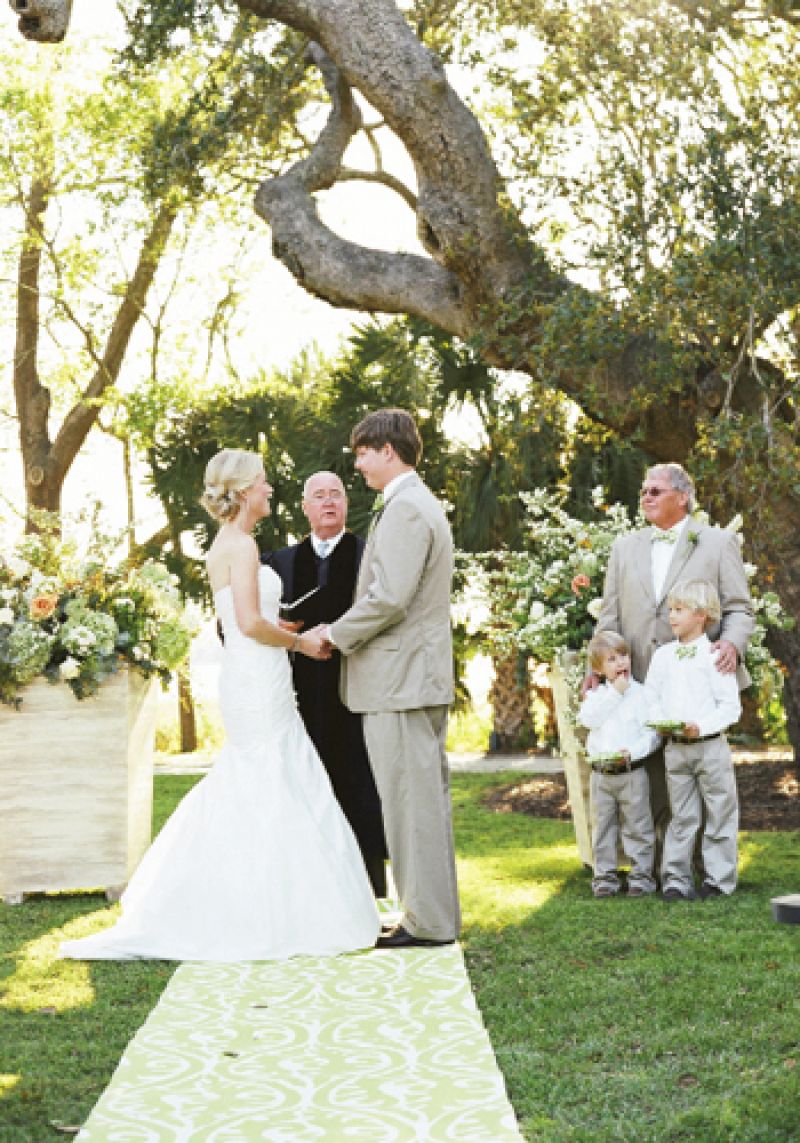 TWO BY TWO: A pair of planters resplendent with blooms framed the couple as they exchanged their vows. The bride’s towheaded nephews stood by with rings at the ready.