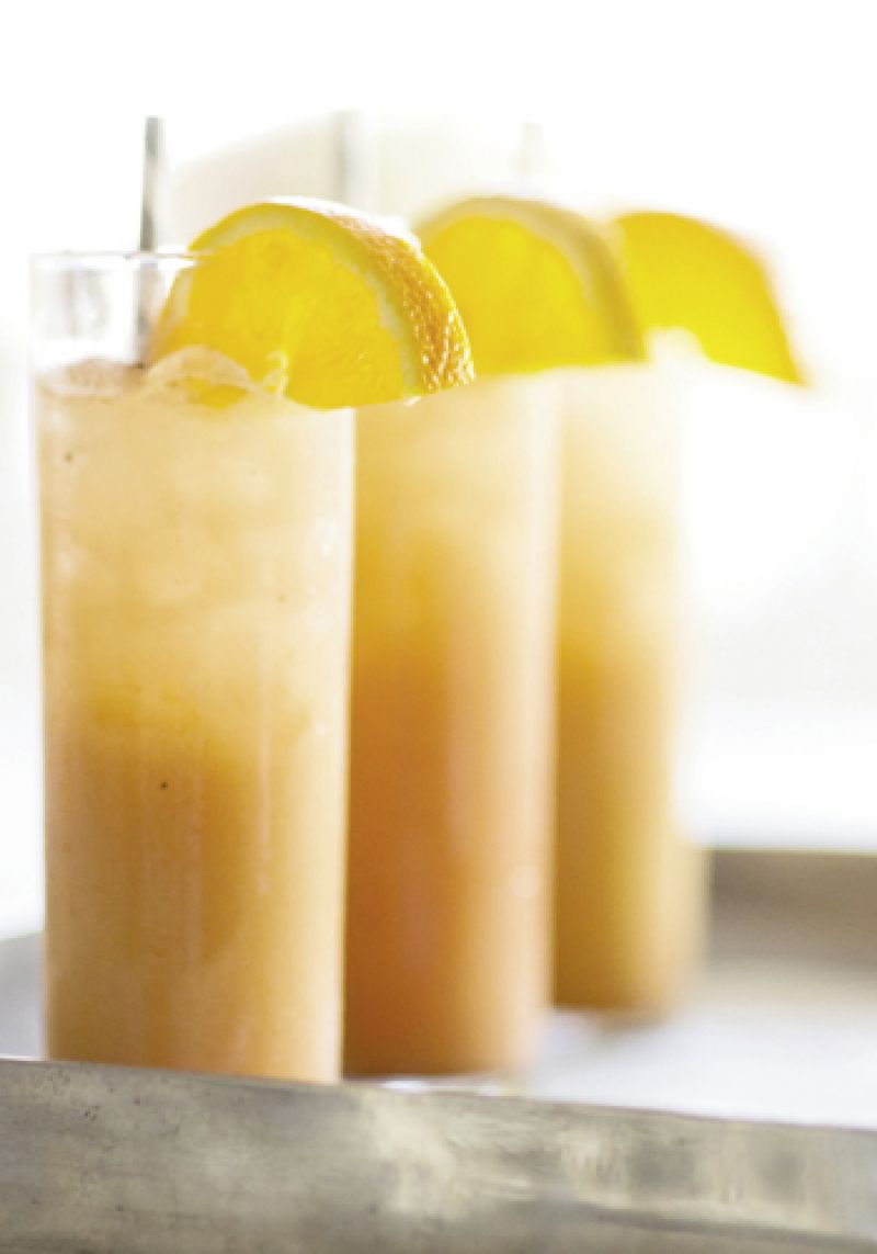 COOL COCKTAIL: Orange slices, striped gray straws, and a specialty cocktail played up the night’s palette.