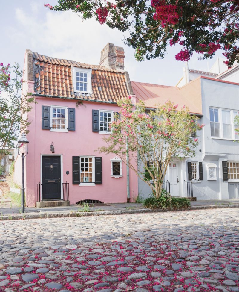 Tickled Pink: Crepe myrtles shower the cobblestones in front of the Pink House with blossoms.