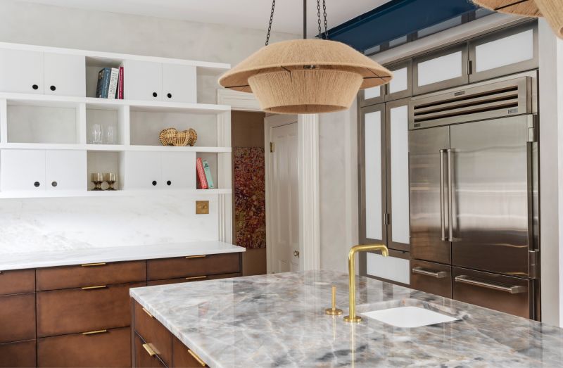 Upper Crust: In place of traditional upper cabinets, Jill Howard designed a decorative floating wall storage unit with sliding doors to hide or reveal its contents. Similarly, a stainless steel “appliance garage” built by Hostetler Custom Cabinetry secrets away clutter such as a toaster and microwave.