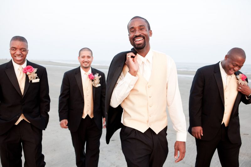 BEST BUDS: Bright boutonnieres added a splash of color to the men’s white, gold, and black three-piece suits.