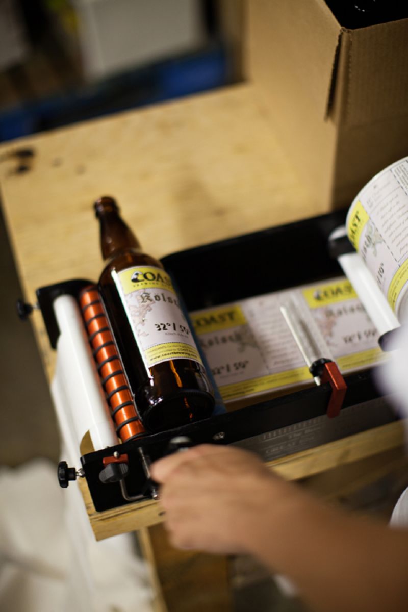COAST&#039;s labeling machine. They label one bottle at a time.