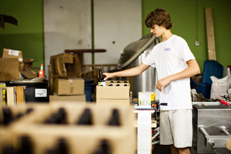 Son Kai labels bottles in preparation for boxing.