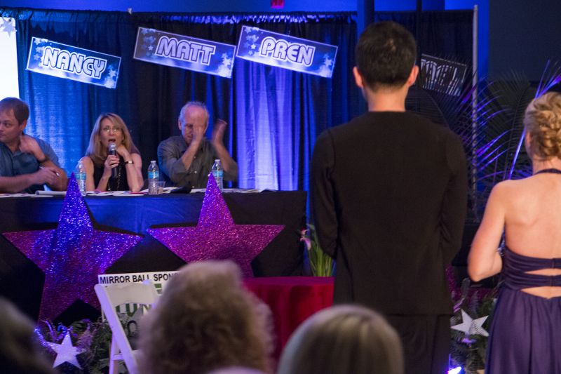 Greer Reagin and James Jiang listen attentively to judges Kenny Walker, Jennifer and Brad Moranz.