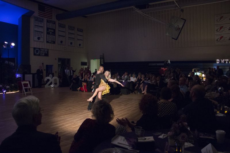 Dancer Cezar Lozada and Mary Early of the Early Family Foundation dance the salsa.