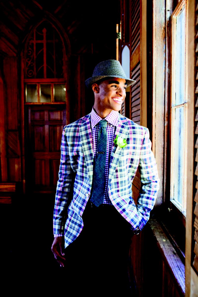 WAITING GAME: Fitzgerald-fit madras sports coat, navy wool garbadine trousers, and argyle Egyptian cotton  socks, all from Brooks  Brothers. Canali’s plaid oxford and Bill Lavin Soft Collection’s snakeskin belt, both from Gwynn’s of Mt. Pleasant. The Hill-side’s black chambray tie from Indigo and Cotton. Tartan tweed fedora and vintage tie clip, both from Billy Reid. OMEGA’s Seamaster Aqua Terra watch in 18K rose gold and stainless steel from Kiawah Fine Jewelry. Boutonniere from Ooh! Events.