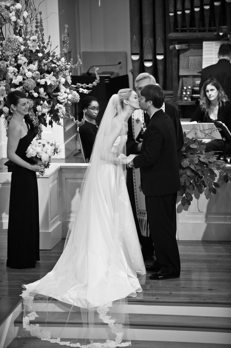 BUNCHES OF BLOOMS: Laura&#039;s bouquet of pink and white peonies and roses was tied off with the sash from her mother&#039;s wedding dress. Bridesmaids carried ranunculus and palmetto roses.