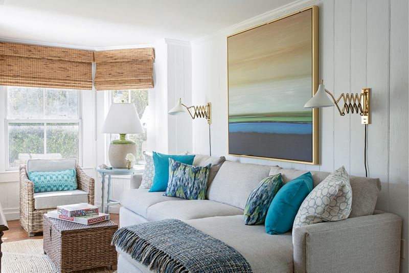 Color Play: In the family room, colorful pillows from Indigo Market complement the abstract landscape from Wendover Art Group.