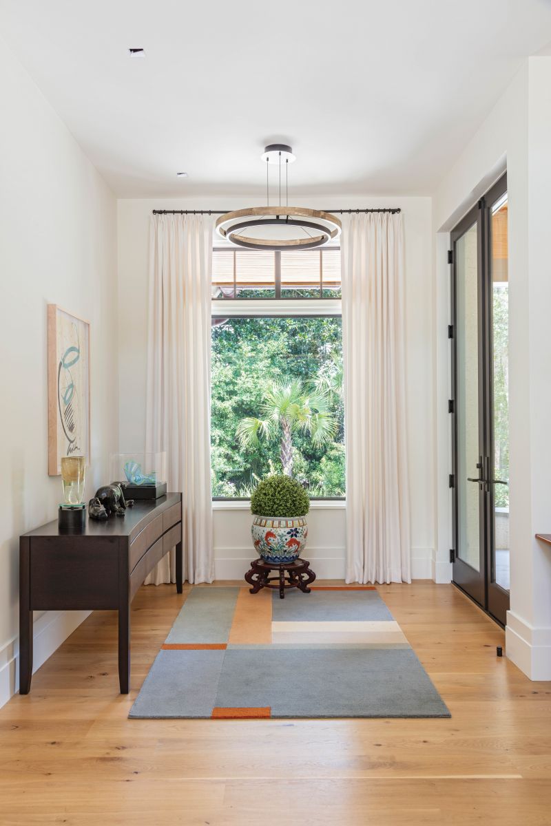 A Dale Chihuly glass sculpture and signed print in the foyer inspired the selection of this geometric “Landscape” rug from Design Within Reach.