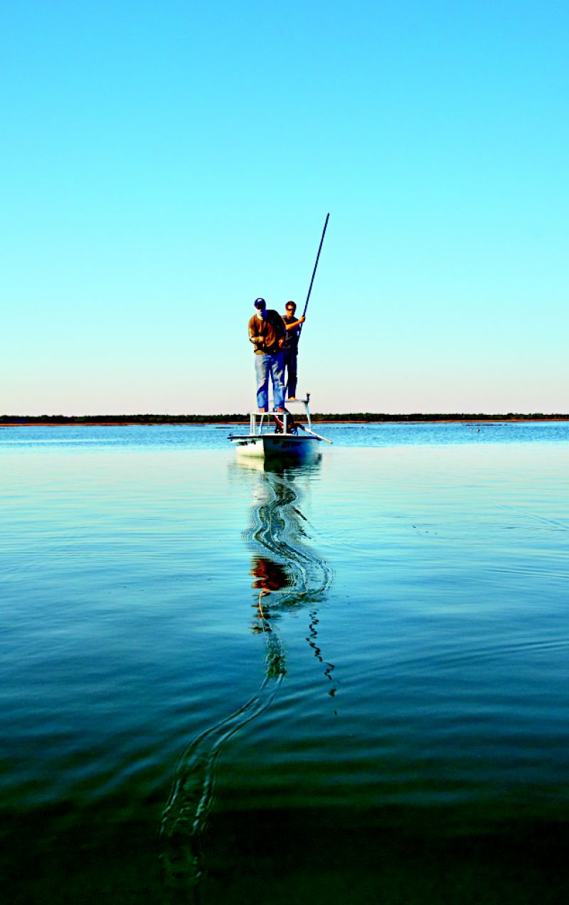 Poling the skiff and casting at low tide