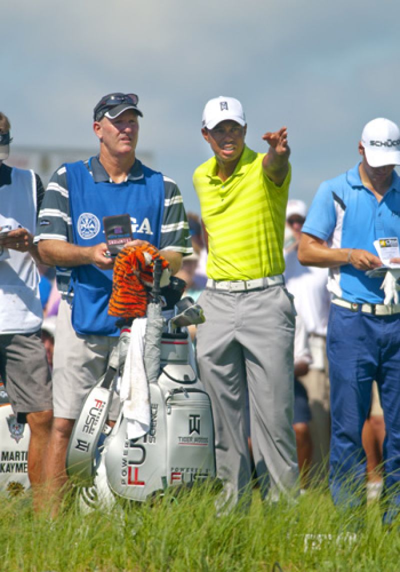 Tiger and his caddie discuss the challenging par 3 17th, the ball did not go where he is pointing.
