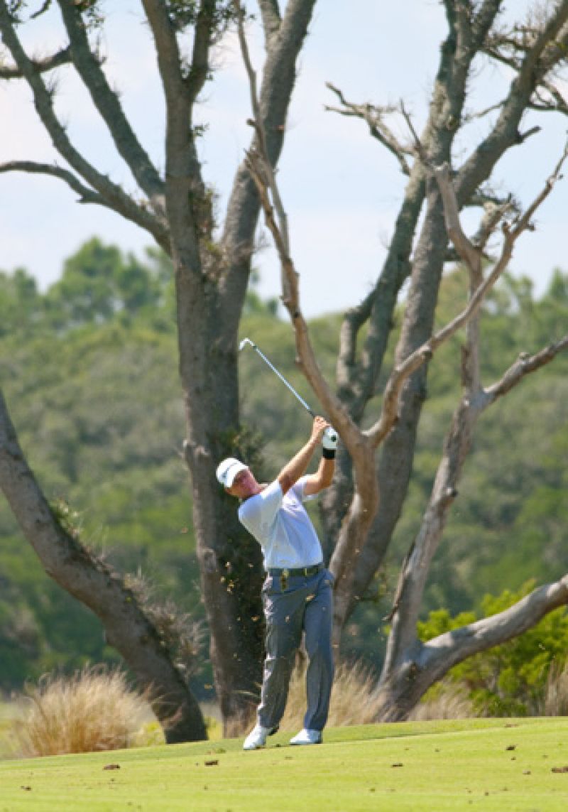 Lofting a hefty divot into the hot afternoon air.