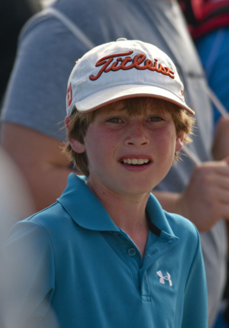 A young fan waiting for a glimpse of some pros.
