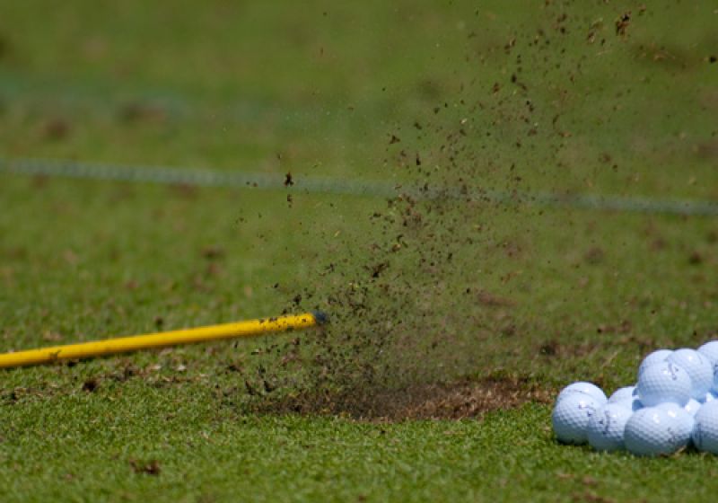 Sending some dirt flying at the practice tees.